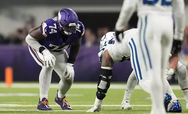 Minnesota Vikings offensive tackle Cam Robinson (74) gets set for a play during the second half of an NFL football game against the Indianapolis Colts, Sunday, Nov. 3, 2024, in Minneapolis. (AP Photo/Abbie Parr)