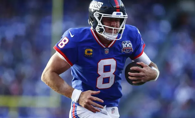 New York Giants quarterback Daniel Jones (8) carries the ball for a touchdown against the Washington Commanders during the fourth quarter of an NFL football game, Sunday, Nov. 3, 2024, in East Rutherford, N.J. (AP Photo/John Munson)