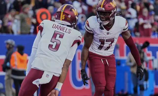 Washington Commanders wide receiver Terry McLaurin (17) celebrates with quarterback Jayden Daniels (5) after scoring a touchdown against the New York Giants during the second quarter of an NFL football game, Sunday, Nov. 3, 2024, in East Rutherford, N.J. (AP Photo/Seth Wenig)