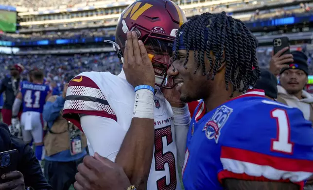 Washington Commanders quarterback Jayden Daniels (5) talks with New York Giants wide receiver Malik Nabers (1) after playing against the New York Giants in an NFL football game, Sunday, Nov. 3, 2024, in East Rutherford, N.J. (AP Photo/Seth Wenig)