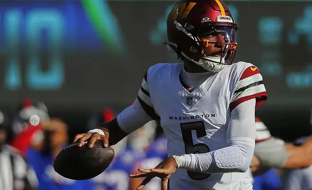 Washington Commanders quarterback Jayden Daniels (5) passes against the New York Giants during the second quarter of an NFL football game, Sunday, Nov. 3, 2024, in East Rutherford, N.J. (AP Photo/John Munson)