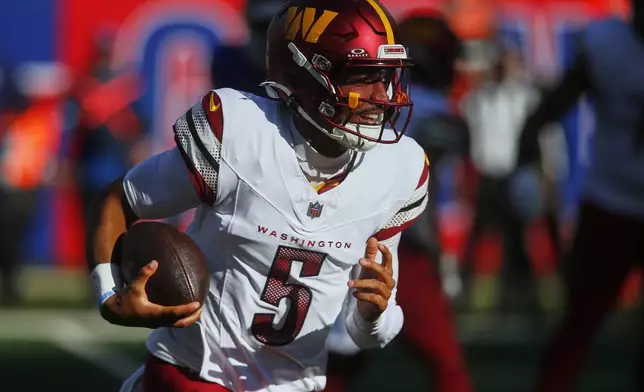 Washington Commanders quarterback Jayden Daniels (5) carries the ball against the New York Giants during the second quarter of an NFL football game, Sunday, Nov. 3, 2024, in East Rutherford, N.J. (AP Photo/John Munson)
