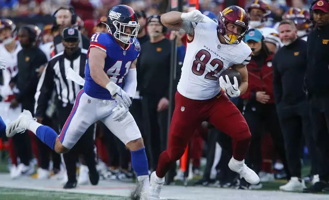 Washington Commanders tight end Ben Sinnott (82) carries the ball against New York Giants linebacker Micah McFadden (41) during the third quarter of an NFL football game, Sunday, Nov. 3, 2024, in East Rutherford, N.J. (AP Photo/John Munson)