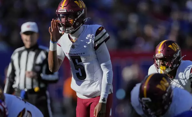 Washington Commanders quarterback Jayden Daniels (5) calls an audible at the line of scrimmage against the New York Giants during the second quarter of an NFL football game, Sunday, Nov. 3, 2024, in East Rutherford, N.J. (AP Photo/Seth Wenig)