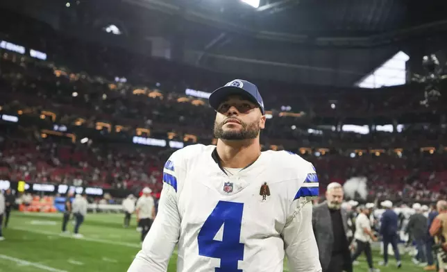 Dallas Cowboys quarterback Dak Prescott (4) walks off the field after an NFL football game against the Atlanta Falcons, Sunday, Nov. 3, 2024, in Atlanta. The Falcons won 27-21. (AP Photo/ Brynn Anderson)