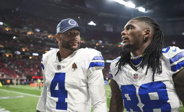 Dallas Cowboys quarterback Dak Prescott (4) walks off the field with wide receiver CeeDee Lamb (88) after an NFL football game against the Atlanta Falcons, Sunday, Nov. 3, 2024, in Atlanta. The Falcons won 27-21. (AP Photo/ Brynn Anderson)