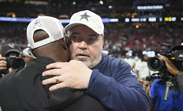 Dallas Cowboys head coach Mike McCarthy, facing, greets Atlanta Falcons head coach Raheem Morris after an NFL football game, Sunday, Nov. 3, 2024, in Atlanta. The Falcons won 27-21. (AP Photo/ Brynn Anderson)