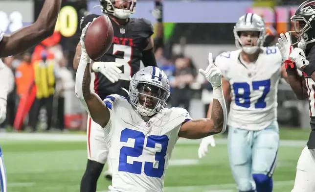 Dallas Cowboys running back Rico Dowdle (23) celebrates a touchdown reception against Atlanta Falcons during the first half of an NFL football game, Sunday, Nov. 3, 2024, in Atlanta. (AP Photo/ Brynn Anderson)