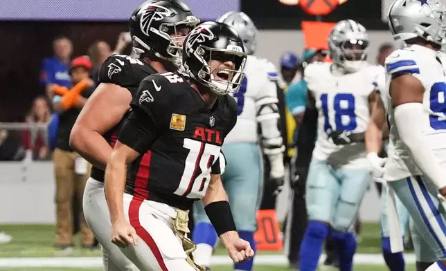 Atlanta Falcons quarterback Kirk Cousins (18) celebrates after a touchdown during the second half of an NFL football game against the Dallas Cowboys, Sunday, Nov. 3, 2024, in Atlanta. (AP Photo/ John Bazemore)