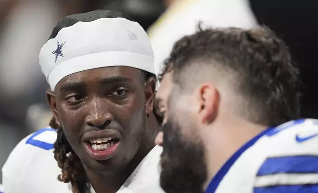 Dallas Cowboys offensive tackle Tyler Guyton talks on the bench during the first half of an NFL football game against the Atlanta Falcons, Sunday, Nov. 3, 2024, in Atlanta. (AP Photo/ Brynn Anderson)