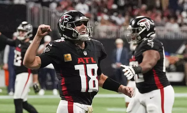 Atlanta Falcons quarterback Kirk Cousins (18) celebrates after a touchdown during the second half of an NFL football game against the Dallas Cowboys, Sunday, Nov. 3, 2024, in Atlanta. (AP Photo/ John Bazemore)