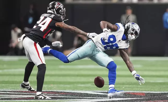 Dallas Cowboys wide receiver CeeDee Lamb (88) drops a pass as he is defended by Atlanta Falcons cornerback A.J. Terrell (24) during the first half of an NFL football game, Sunday, Nov. 3, 2024, in Atlanta. (AP Photo/ Brynn Anderson)