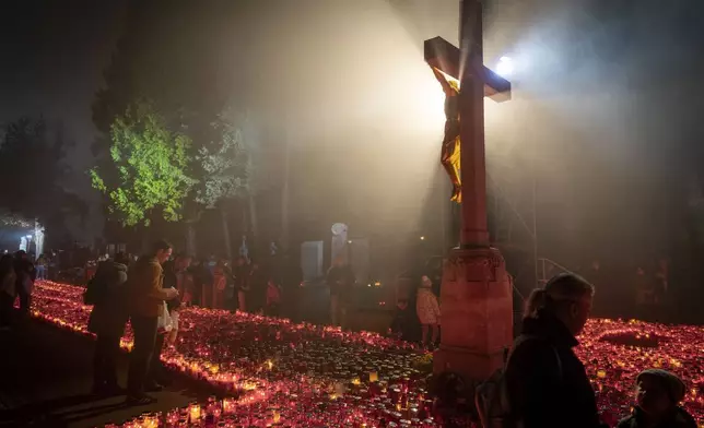 People light candles to honour their deceased at the Mirogoj cemetery in Zagreb, Croatia, Friday, Nov. 1, 2024. (AP Photo/Darko Bandic)