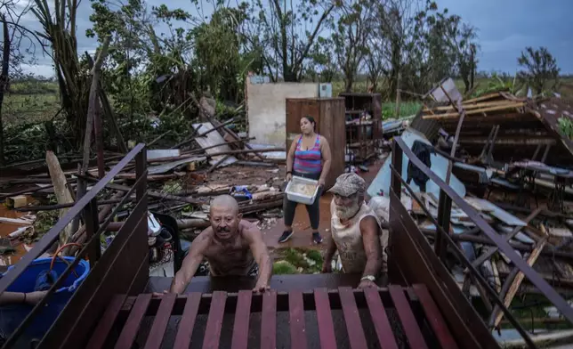 People recover belongings from their houses, which were destroyed by Hurricane Rafael, in Alquizar, Cuba, Thursday, Nov. 7, 2024. (AP Photo/Ramon Espinosa)