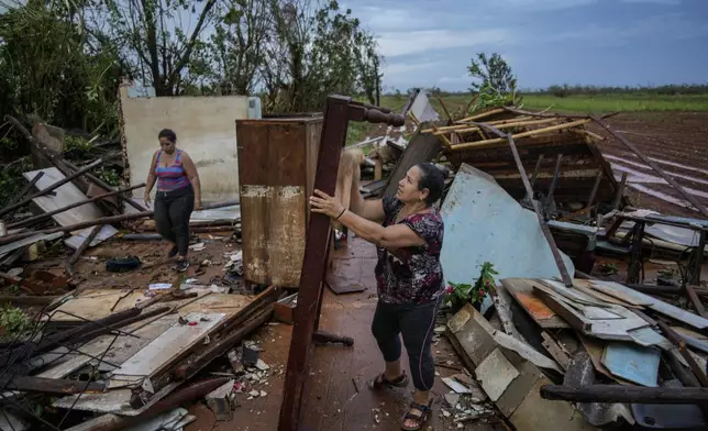 People recover belongings from their houses, which were destroyed by Hurricane Rafael, in Alquizar, Cuba, Thursday, Nov. 7, 2024. (AP Photo/Ramon Espinosa)