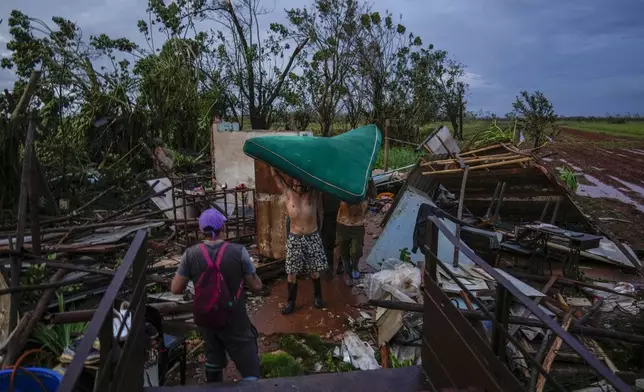 People recover a mattress from their home, which was destroyed by Hurricane Rafael, in Alquizar, Cuba, Thursday, Nov. 7, 2024. (AP Photo/Ramon Espinosa)