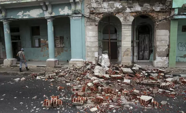 Debris from a building damaged by the passage of Hurricane Rafael covers the street in Havana, Cuba, Thursday, Nov. 7, 2024. (AP Photo/Ariel Ley)