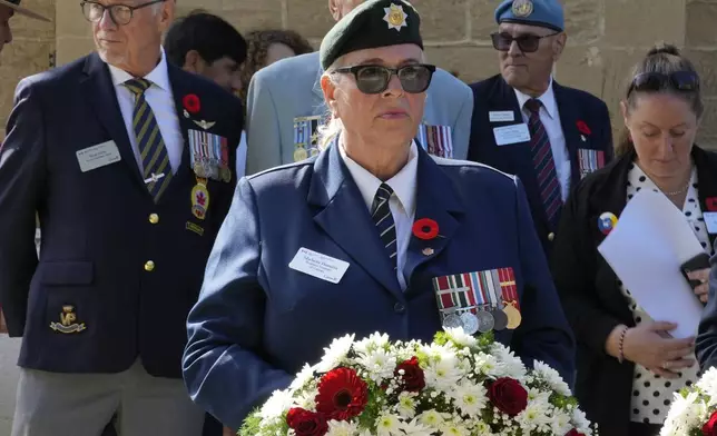 Canadian veteran Michelle Angela Hamelin lays a wreath at the unveiling of a plaque commemorating the 60th anniversary of Canada's contribution to the UN Peacekeeping Force in Cyprus at Wolseley Barracks inside a UN-controlled buffer zone cleaving the capital Nicosia, Cyprus, on Monday, Nov. 11, 2024. (AP Photo/Petros Karadjias)