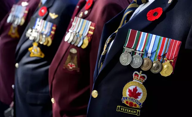 Canadian veterans stand commemorating the 60th anniversary of Canada's contribution to the UN Peacekeeping Force in Cyprus at Wolseley Barracks inside a UN-controlled buffer zone cleaving the capital Nicosia, Cyprus, on Monday, Nov. 11, 2024. (AP Photo/Petros Karadjias)