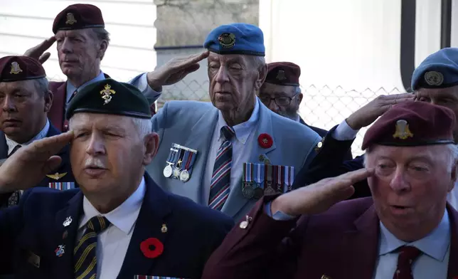 Canadian veteran Ronald Reginald Griffis, center, with others veterans, salutes during a commemoration for the 60th anniversary of Canada's contribution to the UN Peacekeeping Force in Cyprus at Wolseley Barracks inside a UN-controlled buffer zone cleaving the capital Nicosia, Cyprus, on Monday, Nov. 11, 2024. (AP Photo/Petros Karadjias)