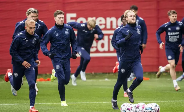 From left, Gustav Isaksen, Mads Roerslev Rasmussen, and Morten Hjulmand practice as the men's national football team trains in Helsingoer, Denmark, Wednesday, Nov. 13, 2024. (Ida Marie Odgaard/Ritzau Scanpix via AP)