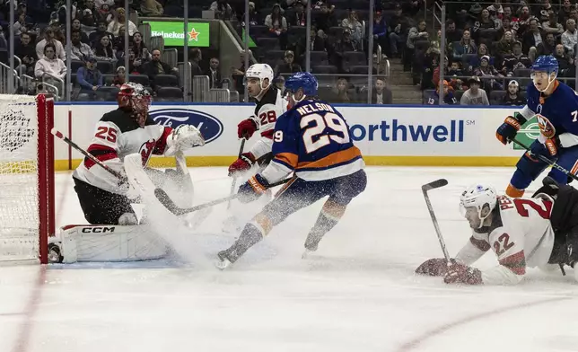 New York Islanders center Brock Nelson (29) shoots during the second period in an NHL hockey game against the New Jersey Devils, Saturday, Nov. 9, 2024, in Elmont, N.Y. (AP Photo/Stefan Jeremiah)