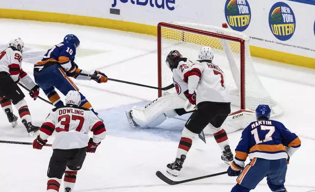 New York Islanders right wing Simon Holmstrom (10) scores a goal during the first period in an NHL hockey game against the New Jersey Devils Saturday, Nov. 9, 2024, in Elmont, N.Y. (AP Photo/Stefan Jeremiah)