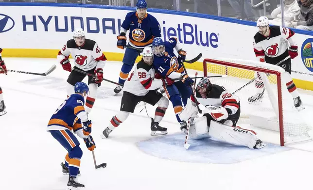 New York Islanders center Brock Nelson (29) shoots during the first period in an NHL hockey game against the New Jersey Devils Saturday, Nov. 9, 2024, in Elmont, N.Y. (AP Photo/Stefan Jeremiah)