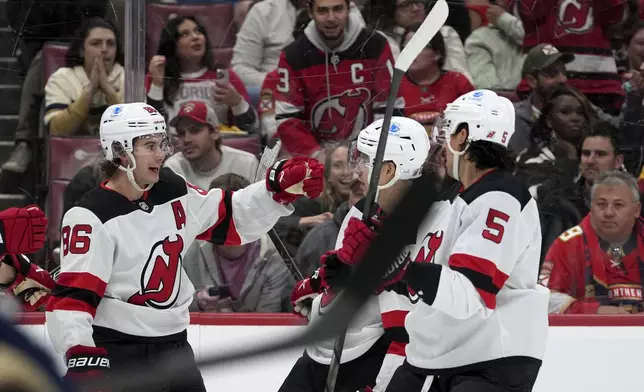 New Jersey Devils center Jack Hughes (86) celebrates after scoring a goal during the first period of an NHL hockey game against the Florida Panthers, Tuesday, Nov. 12, 2024, in Sunrise, Fla. (AP Photo/Lynne Sladky)