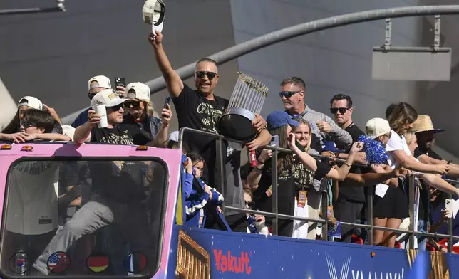 Los Angeles Dodgers manager Dave Roberts tips his hat to the crowd during the baseball team's World Series championship parade Friday, Nov. 1, 2024, in Los Angeles. (AP Photo/Kyusung Gong)