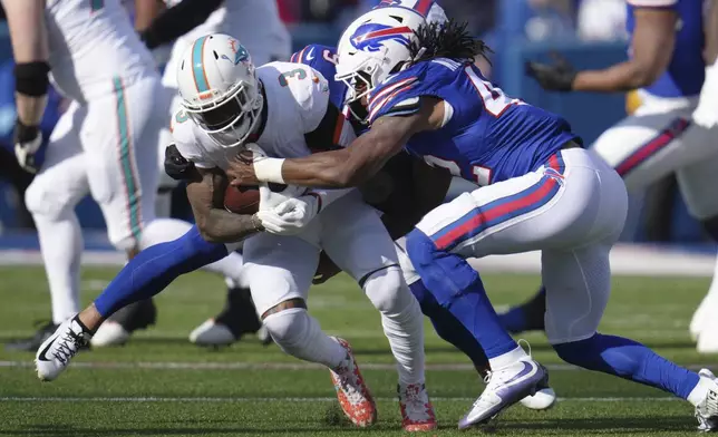 Miami Dolphins wide receiver Odell Beckham Jr. (3) is tackled by Buffalo Bills linebacker Dorian Williams, right, during the first half of an NFL football game Sunday, Nov. 3, 2024, in Orchard Park, N.Y. (AP Photo/Gene Puskar)