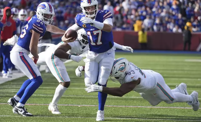 Buffalo Bills quarterback Josh Allen (17) is tackled by Miami Dolphins defensive tackle Calais Campbell (93) during the first half of an NFL football game, Sunday, Nov. 3, 2024, in Orchard Park, N.Y. (AP Photo/Gene Puskar)