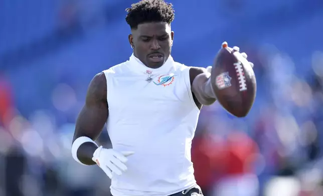 Miami Dolphins wide receiver Tyreek Hill warms up before an NFL football game against the Buffalo Bills, Sunday, Nov. 3, 2024, in Orchard Park, N.Y. (AP Photo/Adrian Kraus)