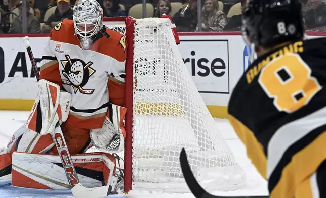 Anaheim Ducks goaltender Lukas Dostal makes a save on a shot by Pittsburgh Penguins' Michael Bunting (8) in the first period of an NHL hockey game Thursday Oct. 31, 2024 in Pittsburgh. The Penguins won 2-1. (Chaz Palla/Pittsburgh Tribune-Review via AP)