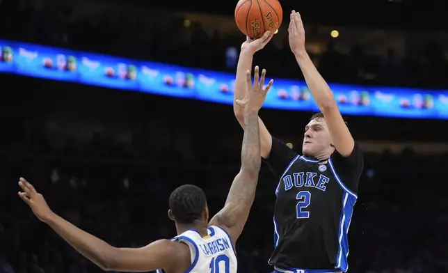 Duke guard Cooper Flagg (2) takes a shot as Kentucky forward Brandon Garrison (10) defends during the second half of an NCAA college basketball game, Tuesday, Nov. 12, 2024, in Atlanta. (AP Photo/John Bazemore )