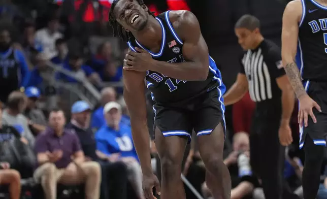 Duke Blue guard Sion James leaves the court after being injured during the second half of an NCAA college basketball game against Kentucky, Tuesday, Nov. 12, 2024, in Atlanta. (AP Photo/John Bazemore)