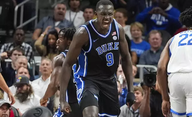 Duke Blue center Khaman Maluach (9) reacts after a Blue Divila's basket during the first half of an NCAA college basketball game against Kentucky, Tuesday, Nov. 12, 2024, in Atlanta. (AP Photo/John Bazemore )