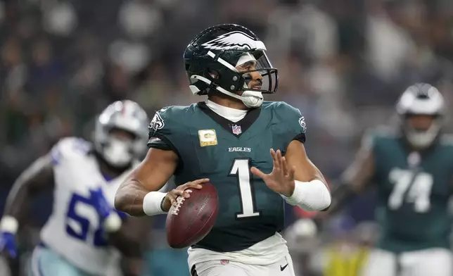 Philadelphia Eagles' Jalen Hurts prepares to throw a pass in the second half of an NFL football game against the Dallas Cowboys in Arlington, Texas, Sunday, Nov. 10, 2024. (AP Photo/Jeffrey McWhorter)