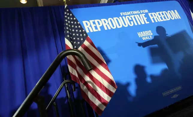 FILE - The shadow of Sen. Amy Klobuchar, D-Minn., is cast on a backdrop as she speaks at an event kicking off a national "Reproductive Freedom Bus Tour" by the campaign of Democratic presidential nominee Vice President Kamala Harris and running mate Gov. Tim Walz, Tuesday, Sept. 3, 2024, in Boynton Beach, Fla. (AP Photo/Rebecca Blackwell, File)