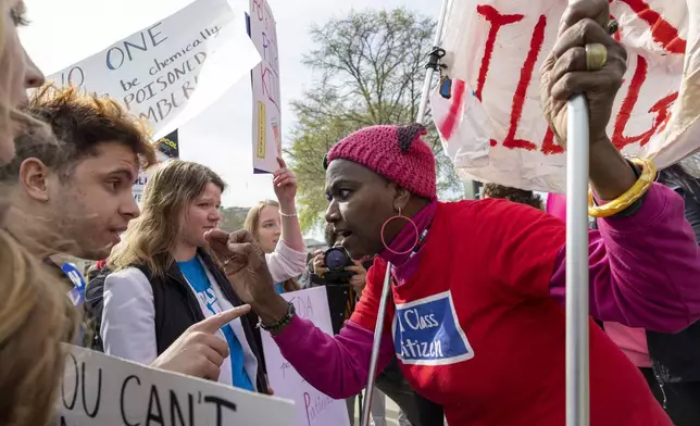 FILE - Anti-abortion activist Caleb Buck, left, argues with abortion-rights activist Nadine Seiler outside the Supreme Court, Tuesday, March 26, 2024, in Washington. (AP Photo/Amanda Andrade-Rhoades, File)