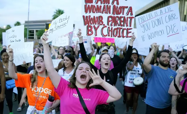 FILE - Protesters join thousands marching around the Arizona Capitol in Phoenix, protesting the U.S. Supreme Court's decision to overturn Roe v. Wade, June 24, 2022. (AP Photo/Ross D. Franklin, File)