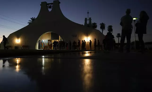 Voters stand in line outside a polling place at Madison Church, Tuesday, Nov. 5, 2024, in Phoenix, Ariz. (AP Photo/Matt York)