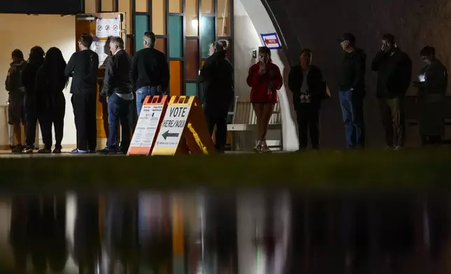 Voters stand in line outside a polling place at Madison Church, Tuesday, Nov. 5, 2024, in Phoenix, Ariz. (AP Photo/Matt York)