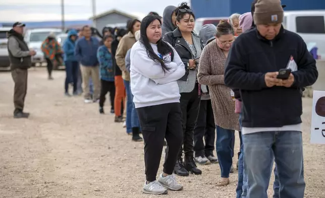 Voters wait in line to cast their ballots outside a polling station on the Navajo Nation in Chinle, Ariz., on Election Day, Tuesday, Nov. 5, 2024. (AP Photo/Andres Leighton)