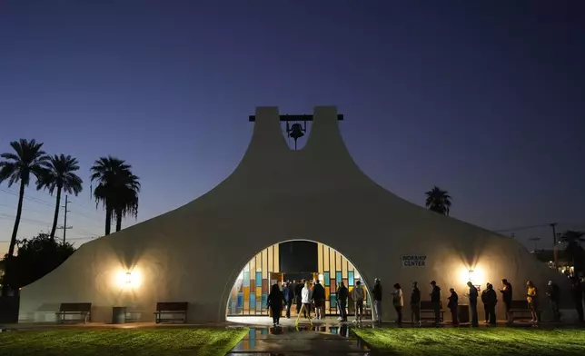 Voters stand in line outside a polling place at Madison Church, Tuesday, Nov. 5, 2024, in Phoenix, Ariz. (AP Photo/Matt York)