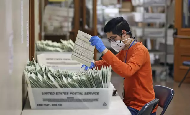 Andrew Chen sorts ballots at San Francisco Department of Elections in City Hall in San Francisco on Wednesday, Nov. 6, 2024. (Scott Strazzante/San Francisco Chronicle via AP)