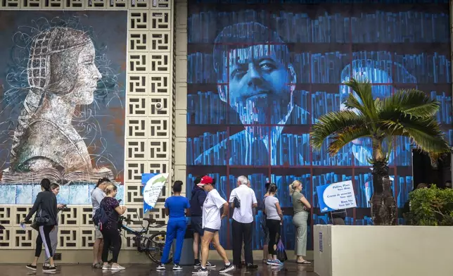 Voters line up to cast their ballots at John F Kennedy Library during Election Day on Tuesday, Nov. 5, 2024 in Hialeah, Fla. (Jose Iglesias/Miami Herald via AP)