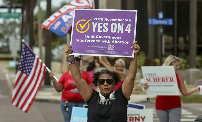 Beth Weinstein rallies in supporter of Yes on Amendment 4 regarding abortion in Florida outside of the polling place at the courthouse on Tuesday, Nov. 5, 2024, in Clearwater, Fla. (AP Photo/Mike Carlson)