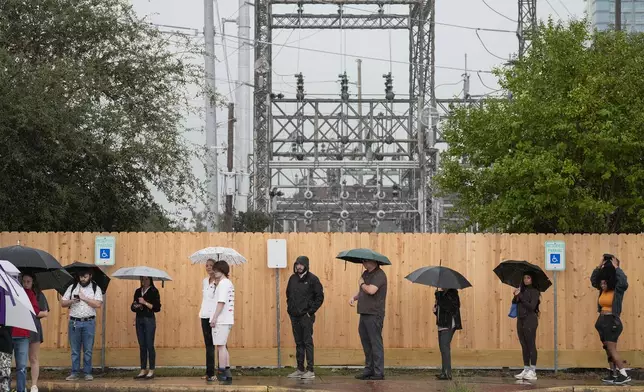 Rain pours down while voters are waiting in line to cast their vote on Election Day Tuesday, Nov. 5, 2024 at West Gray Multiservice Center in Houston. (Yi-Chin Lee/Houston Chronicle via AP)