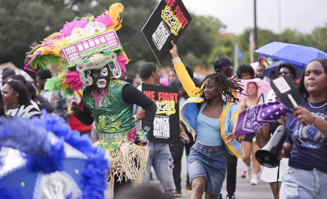 Students march and dance to a campus polling place on Election Day at Southern University in Baton Rouge, La., Tuesday, Nov. 5, 2024. (AP Photo/Gerald Herbert)